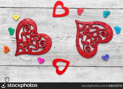 Symbolic hearts on red background. Valentine symbolic heart of buttons on bright background.