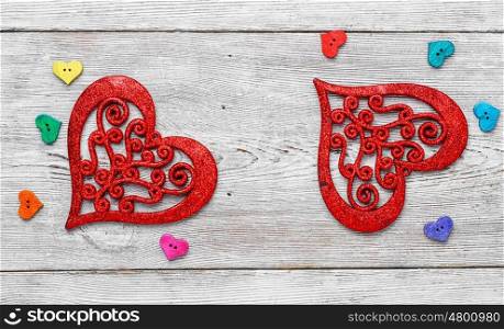 Symbolic hearts on red background. Valentine symbolic heart of buttons on bright background.