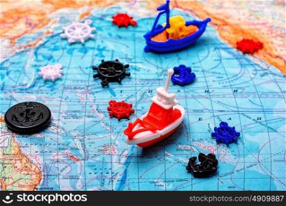 Symbolic ship on the map. Symbolic toy ship on a topographic map of the world