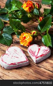 Symbolic wooden heart and flowers. decorative hearts, fragrant roses for Valentines Day