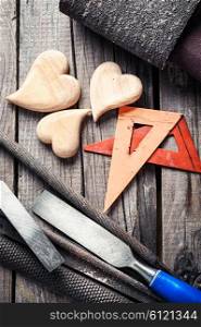 Symbolic wooden hearts cut by hand and carpenter tools. Set woodworking tool