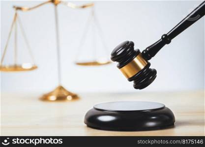 Symbolizing justice and legal authority, golden balanced scale and gavel on desk with law book in lawyer office background, reflecting concept of equality and fair judgment. equility. Golden balanced scale and gavel on desk with book in law office. equility