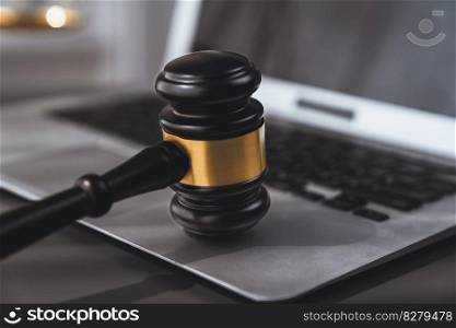 Symbolizing justice and legal authority, golden balanced scale and gavel on desk with laptop in law office background, reflecting concept of equality and fair judgment by lawyer and judge. equility. Golden balanced scale and gavel on desk with laptop in law office. equility