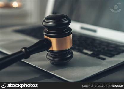 Symbolizing justice and legal authority, golden balanced scale and gavel on desk with laptop in law office background, reflecting concept of equality and fair judgment by lawyer and judge. equility. Golden balanced scale and gavel on desk with laptop in law office. equility