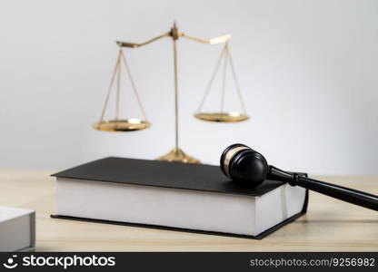 Symbolizing justice and legal authority, golden balanced scale and gavel on desk with law book in lawyer office background, reflecting concept of equality and fair judgment. equility. Golden balanced scale and gavel on desk with book in law office. equility