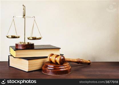 Symbols of law: wood gavel, soundblock, scales and two thick old books