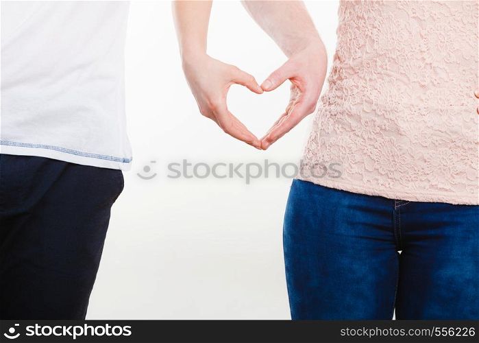 Symbols of love. Couple showing their connection and feelings by holding their hands strongly in shape of heart. Body language as expression of mind state.. Couple holding their hands.