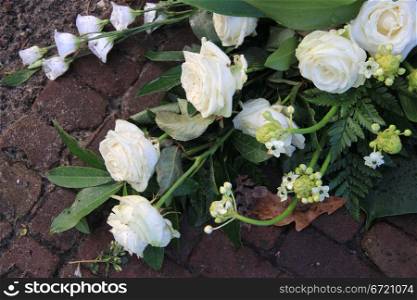 Sympathy flower arrangement with white roses and lilies
