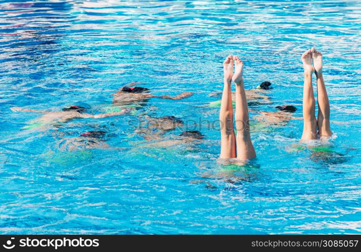 Synchronized swimmers performance with legs outside water
