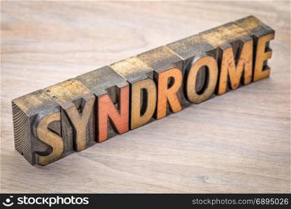 syndrome word abstract in vintage wood letterpress type