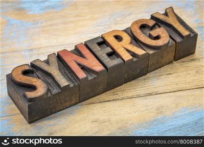 synergy word in vintage letterpress wood type printing blocks stained by color inks