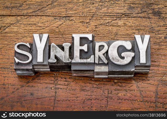 synergy word in vintage metal type printing blocks over grunge wood