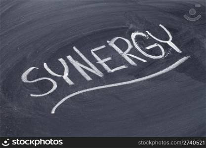 synergy word in white chalk handwriting on blackboard