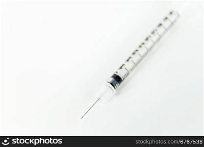 Syring with needle on white table