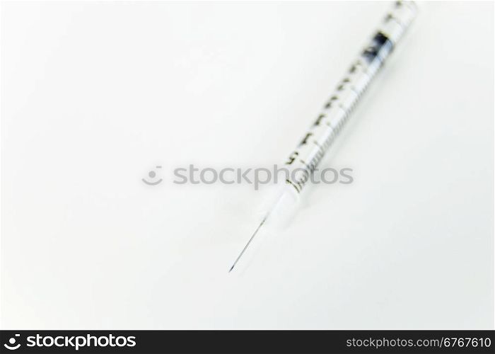 Syring with needle on white table with copy space