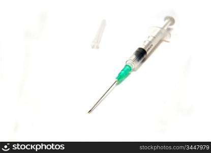 Syringe and cap on white background