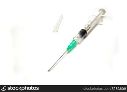 Syringe and cap on white background