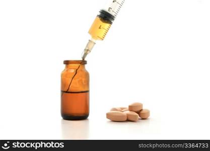Syringe, glass bottle and pills isolated on white background