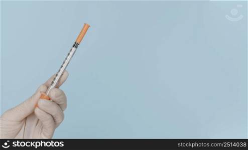 syringe hand wearing glove with copy space