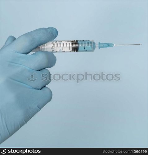 syringe hands wearing glove