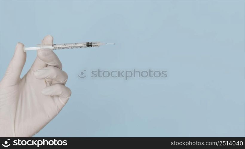 syringe hands wearing glove with copy space