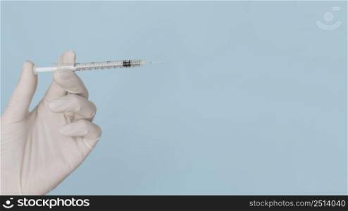syringe hands wearing glove with copy space