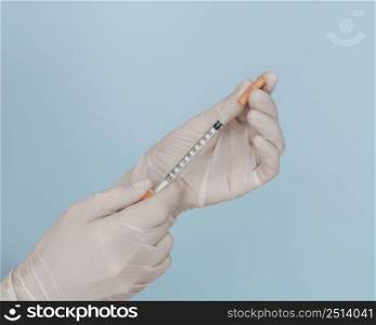 syringe hands wearing gloves