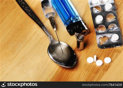 syringe, spoon ,pills,bullet and lighter on the floor