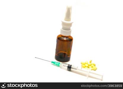 Syringe, tablets and bottle on white background