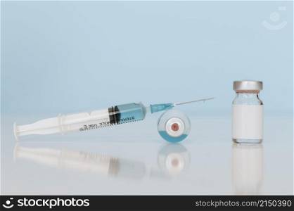 syringe vaccine bottles table