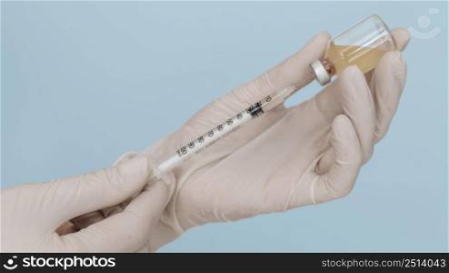 syringe vaccine hands wearing gloves