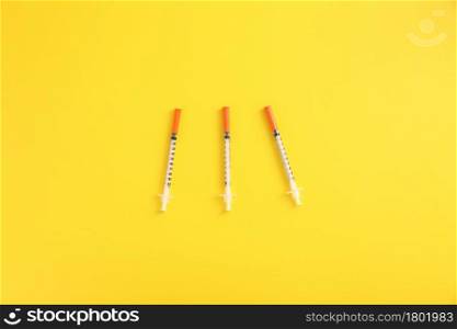 Syringe vaccine isolated in yellow background