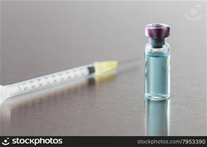 Syringe with antibiotics on a medical table
