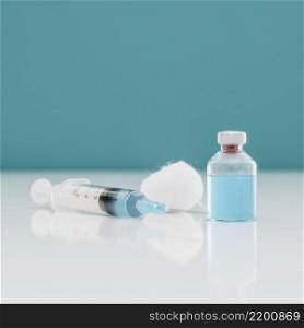 syringe with cotton vaccine bottle table