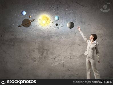 System of planets. Young businesswoman reaching hand to space planets