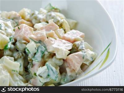 Szalot - Silesian potato salad made with squares of boiled potatoes, carrots, peas, ham, various sausages, pickled fish, boiled eggs