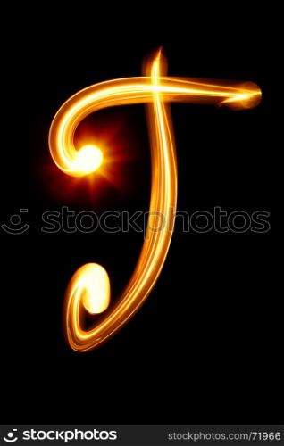 T - Created by light alphabet over black background