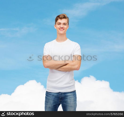 t-shirt design, advertising, dream and people concept - smiling young man in blank white t-shirt over blue sky background