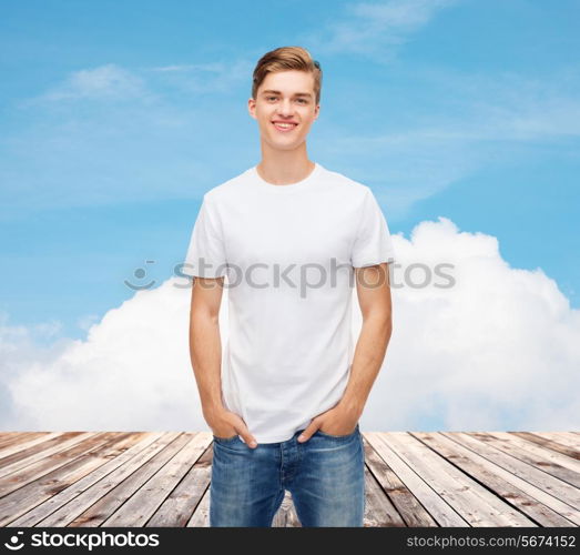 t-shirt design, advertising, vacation and people concept - smiling young man in blank white t-shirt over wooden berth and blue sky background