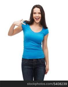 t-shirt design and gesture concept - smiling girl in blank blue t-shirt pointing her finger at herself