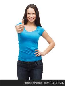 t-shirt design and happy people concept - smiling girl in blank blue t-shirt showing thumbs up