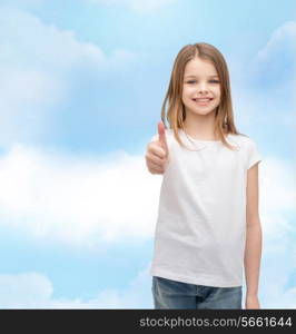 t-shirt design and happy people concept - smiling little girl in blank white t-shirt showing thumbs up