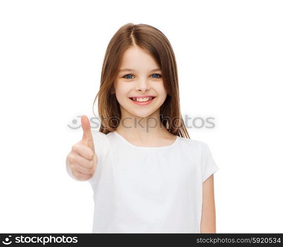 t-shirt design and happy people concept - smiling little girl in blank white t-shirt showing thumbs up. little girl in blank white tshirt showing thumbsup