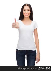 t-shirt design and happy people concept - smiling woman in blank white t-shirt showing thumbs up