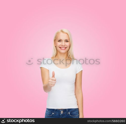 t-shirt design and happy people concept - woman in blank white t-shirt showing thumbs up