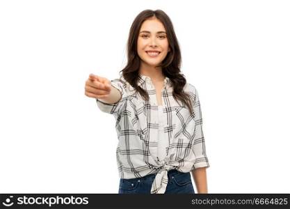 t-shirt design and people concept - smiling young woman in checkered shirt pointing finger at you over white background. young woman or teenage girl pointing finger at you