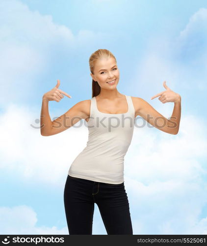 t-shirt design concept - happy woman in blank white t-shirt pointing at herself