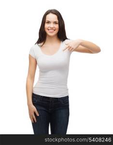 t-shirt design concept - smiling teenager in blank white t-shirt pointing her finger at herself
