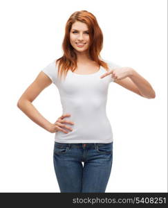 t-shirt design concept - smiling teenager in blank white t-shirt pointing her finger at herself