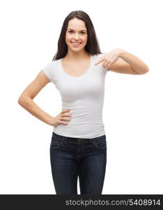 t-shirt design concept - smiling teenager in blank white t-shirt pointing her finger at herself